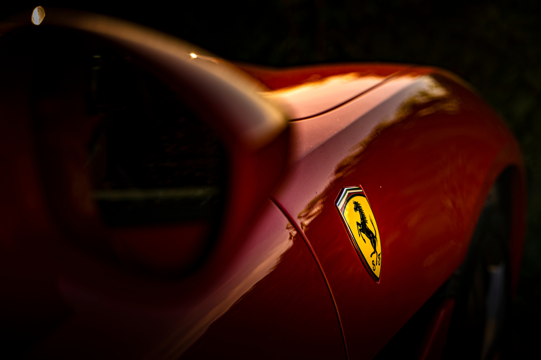 Selective Focus Photo of Ferrari Emblem